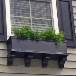 short black window box with four closely spaced brackets underneath