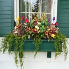 green winter window box with decorative flower arrangement